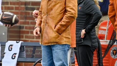Matthew McConaughey wearing a cowboy hat at a Texas football game
