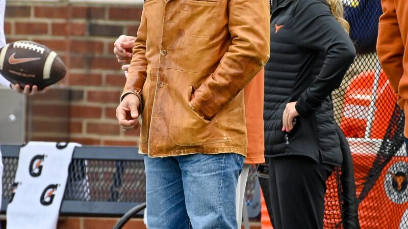 Matthew McConaughey wearing a cowboy hat at a Texas football game