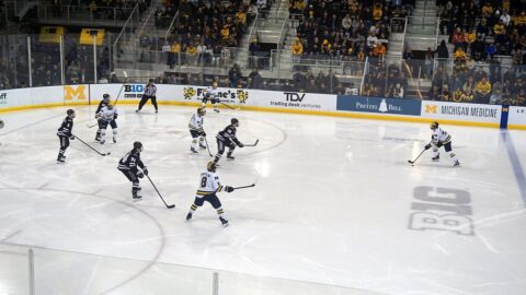 Ice hockey game in progress in a large arena