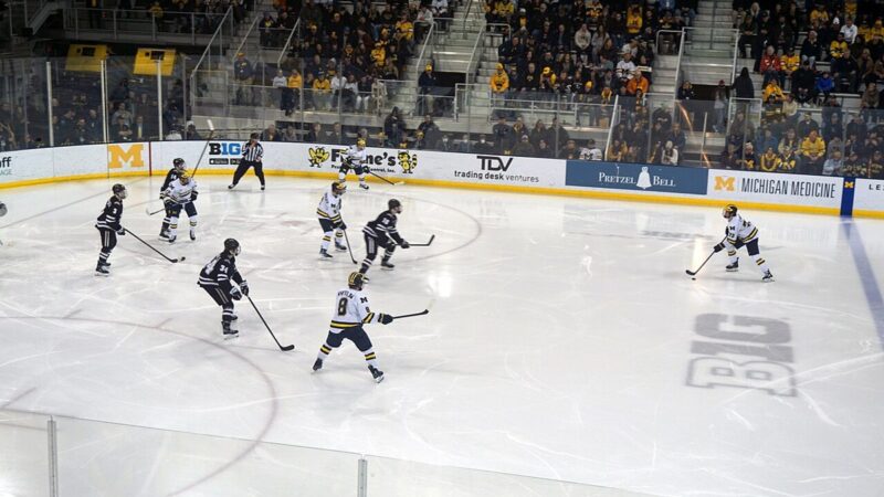 Ice hockey game in progress in a large arena