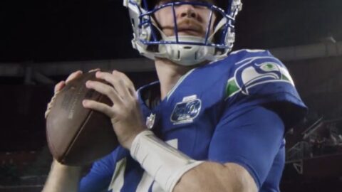 Sam Darnold in Seattle Seahawks uniform holding a football