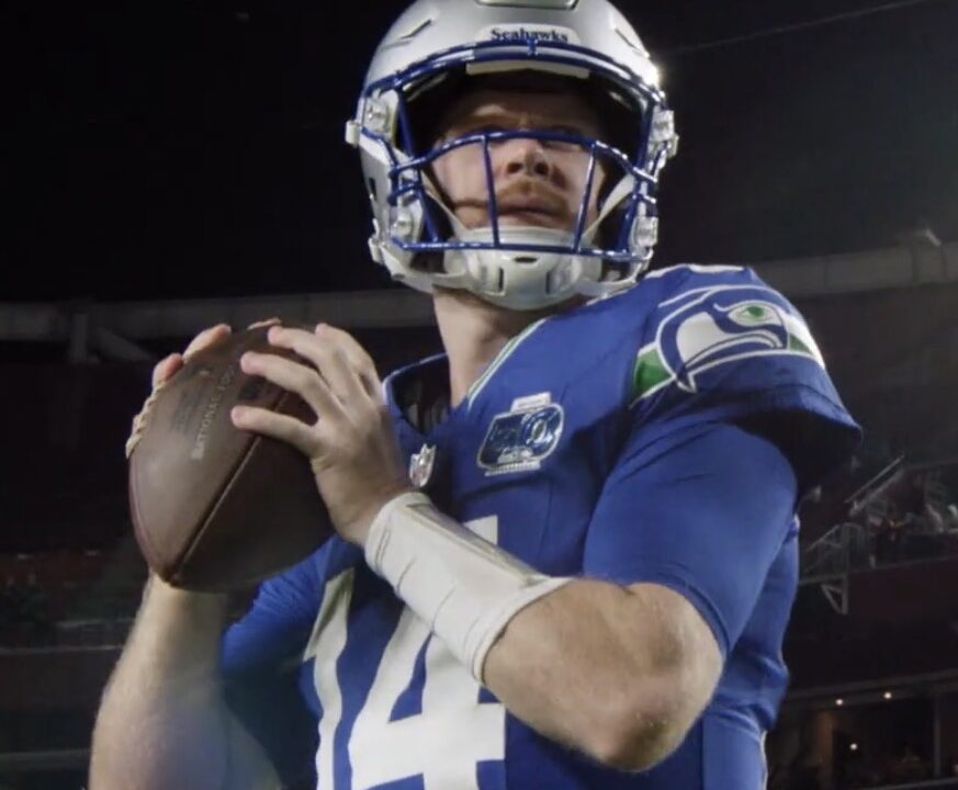 Sam Darnold in Seattle Seahawks uniform holding a football